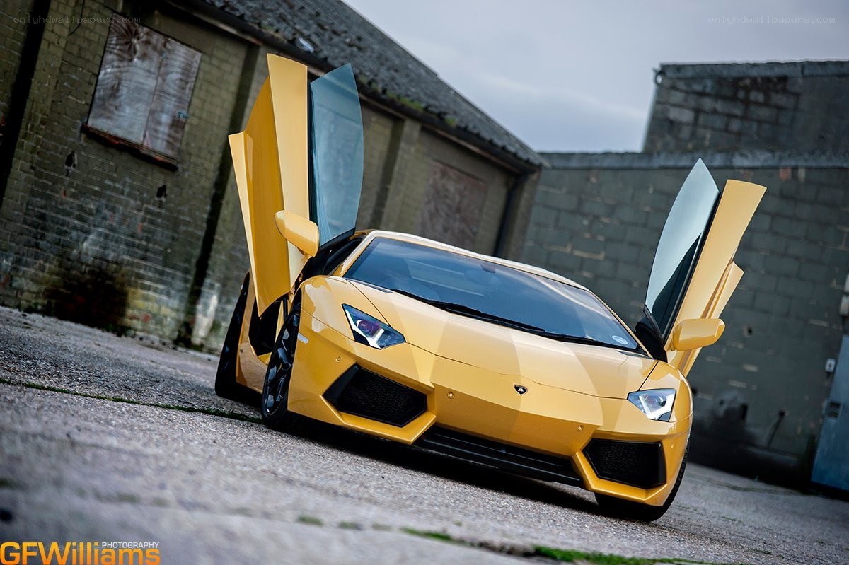 yellow lamborghini with doors open