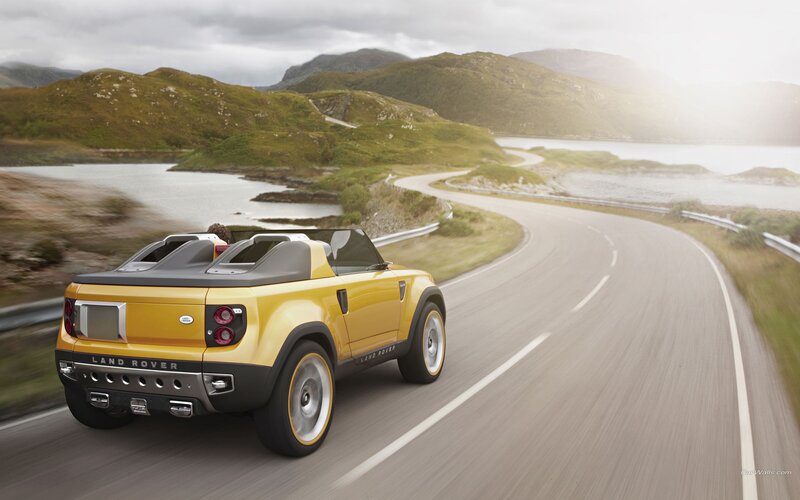Yellow Land Rover on coastal road