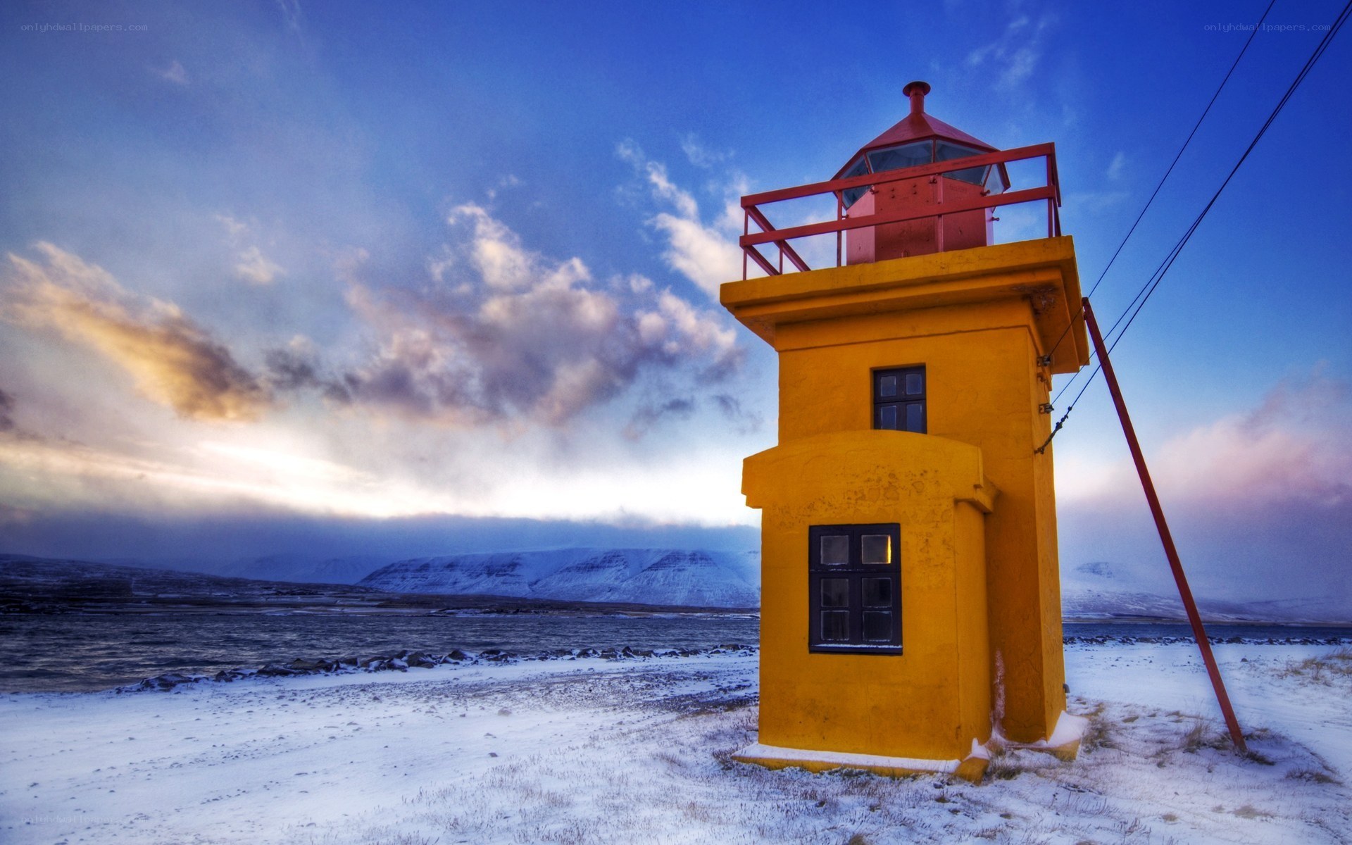 Yellow lighthouse in snowy landscape