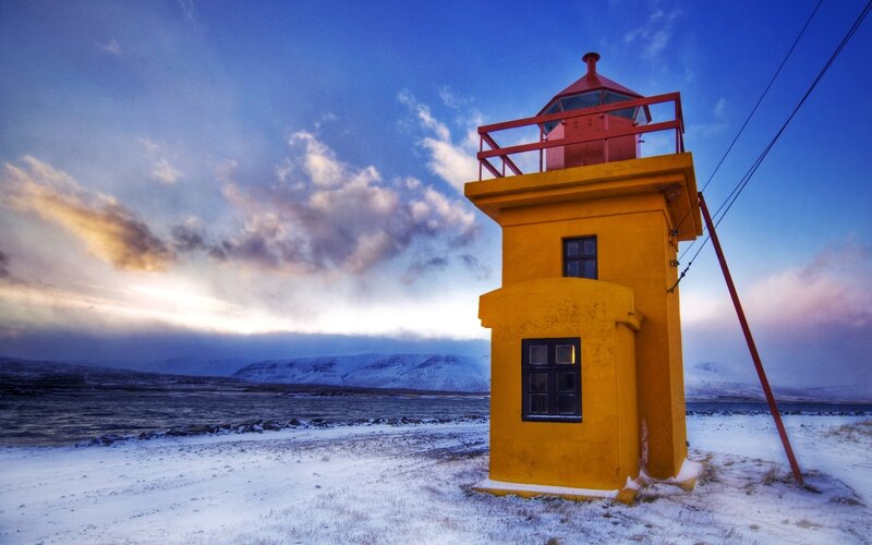 Yellow lighthouse in snowy landscape