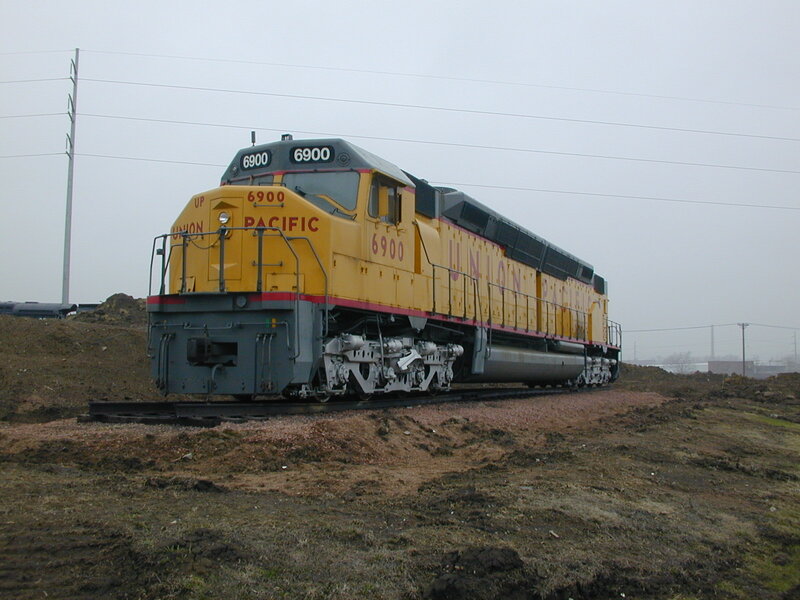 Yellow Locomotive on Tracks — Overcast