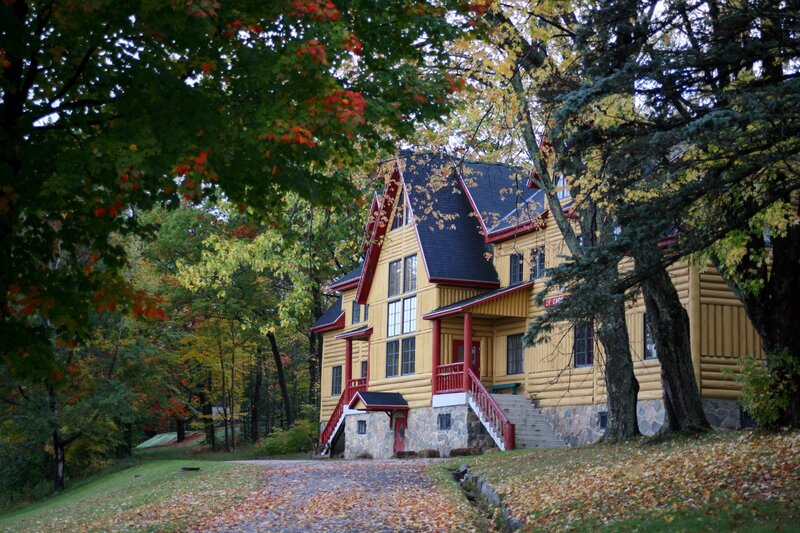 Yellow log cabin in autumn forest