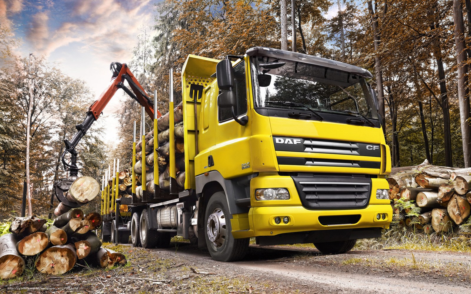 Yellow logging truck in forest
