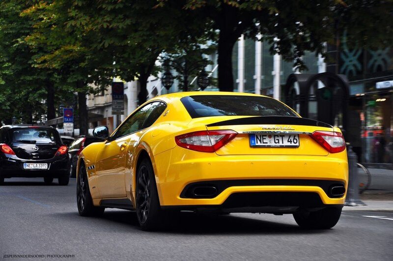 Yellow Maserati on city street