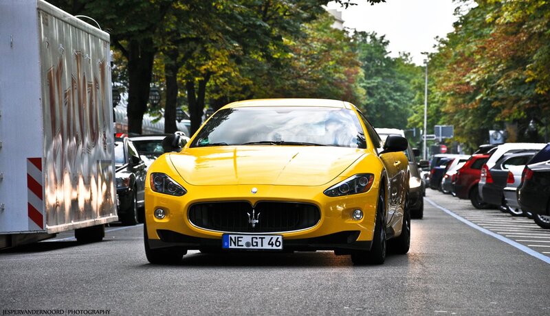 Yellow Maserati on city street