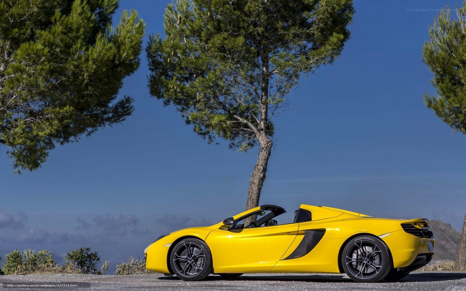 Yellow McLaren convertible on a hill