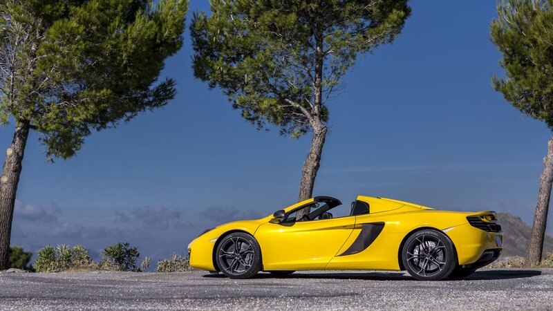 Yellow McLaren convertible on a scenic road