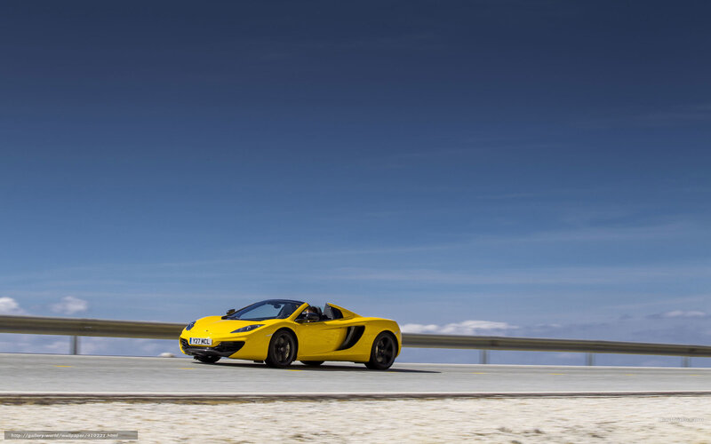 Yellow McLaren on a coastal road
