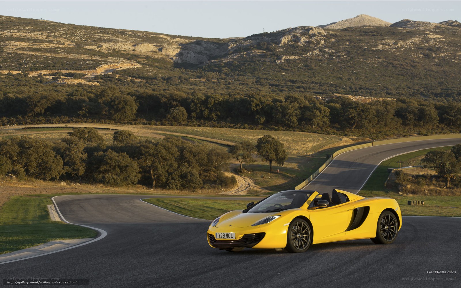 Yellow McLaren on a winding road