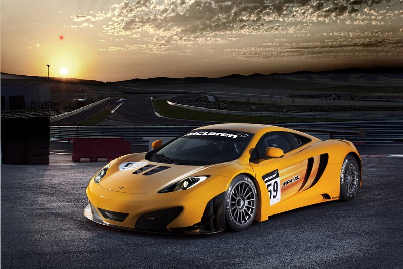 Yellow McLaren race car at sunset