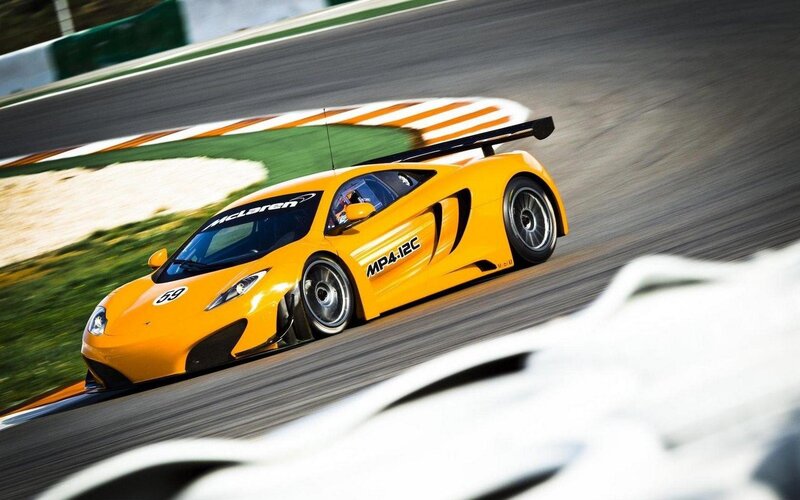 Yellow McLaren race car on track