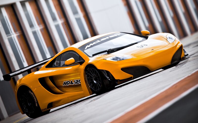 Yellow McLaren race car on track