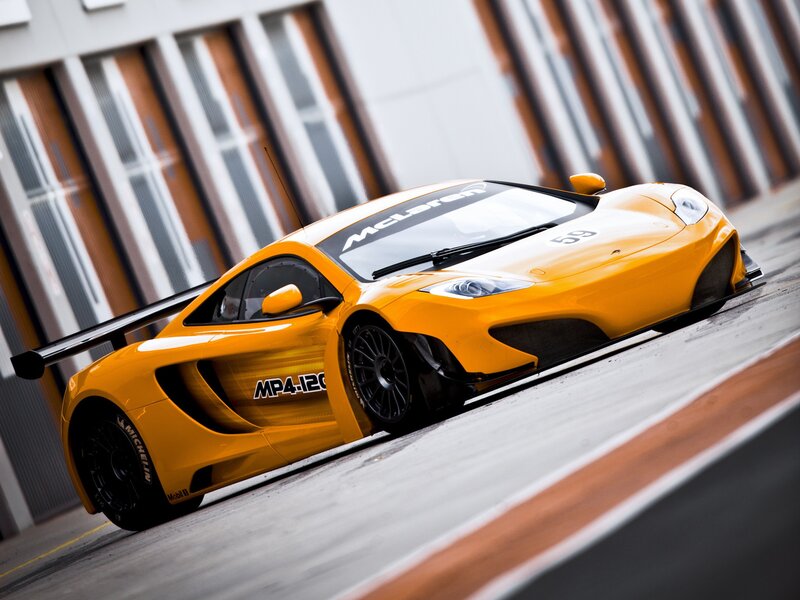 Yellow McLaren race car on track