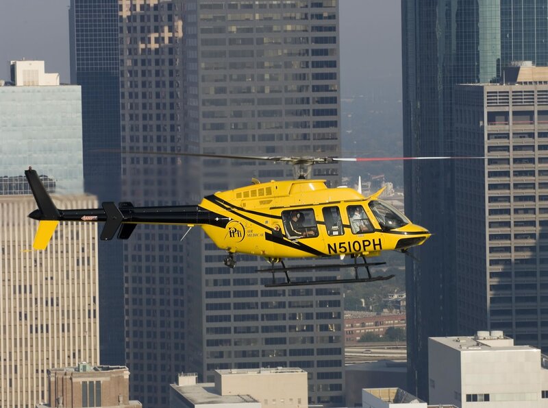Yellow medical helicopter in city