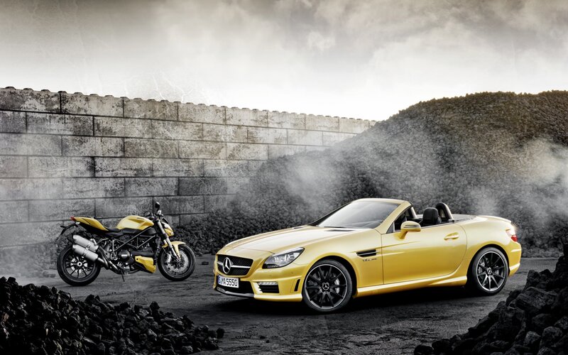 Yellow Mercedes-Benz SLK and motorcycle