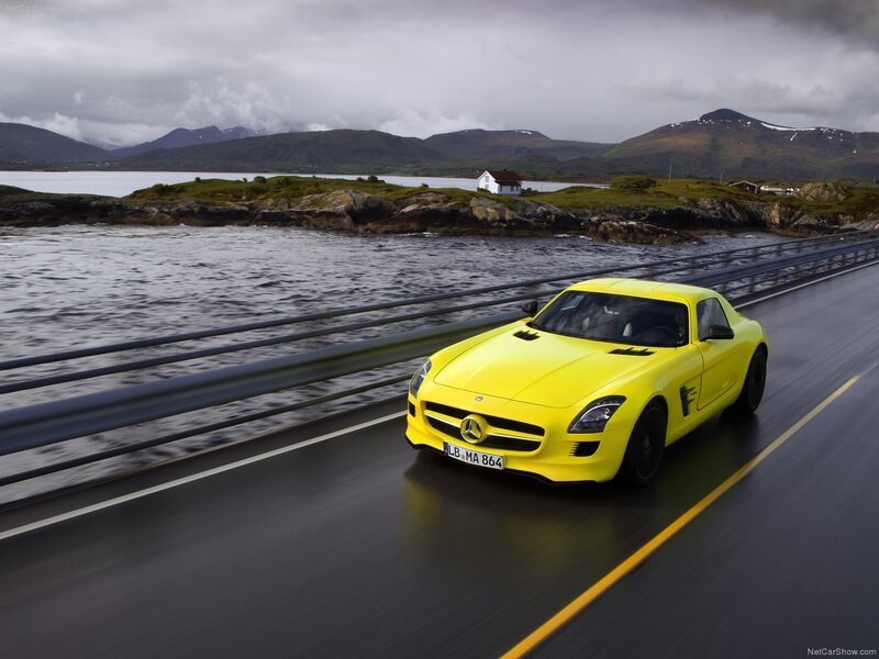 Yellow Mercedes-Benz SLS AMG on a coastal road