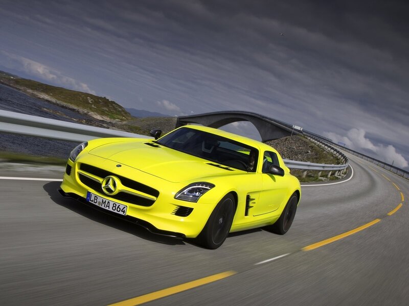 Yellow Mercedes-Benz SLS AMG on coastal road