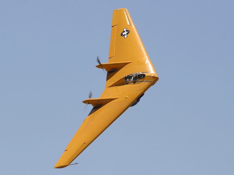 yellow military aircraft in flight
