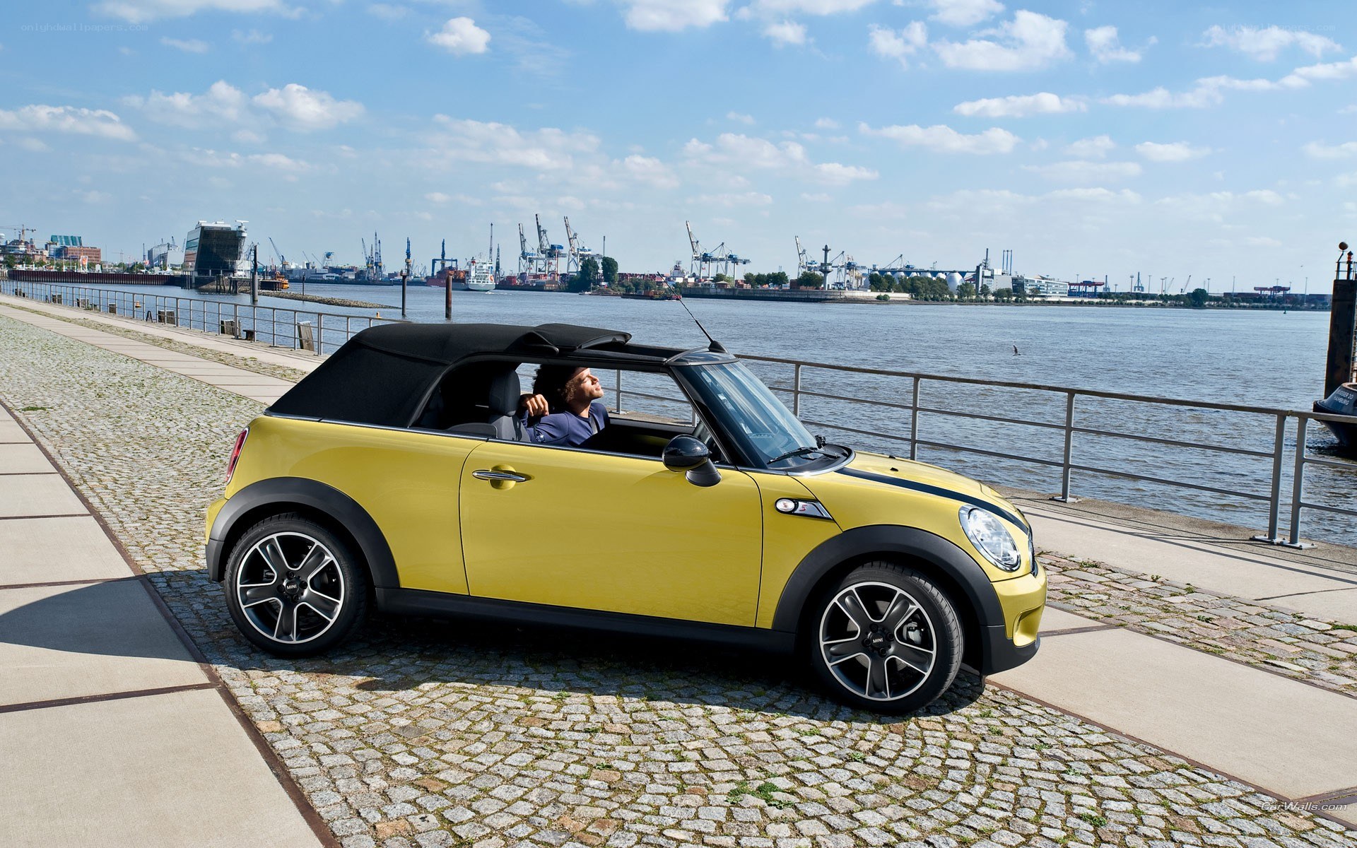 Yellow MINI convertible by the water