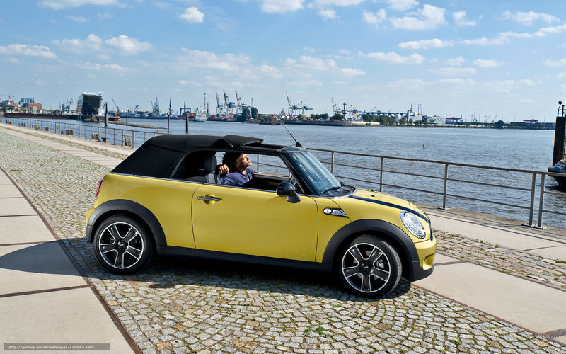 Yellow MINI convertible by the water