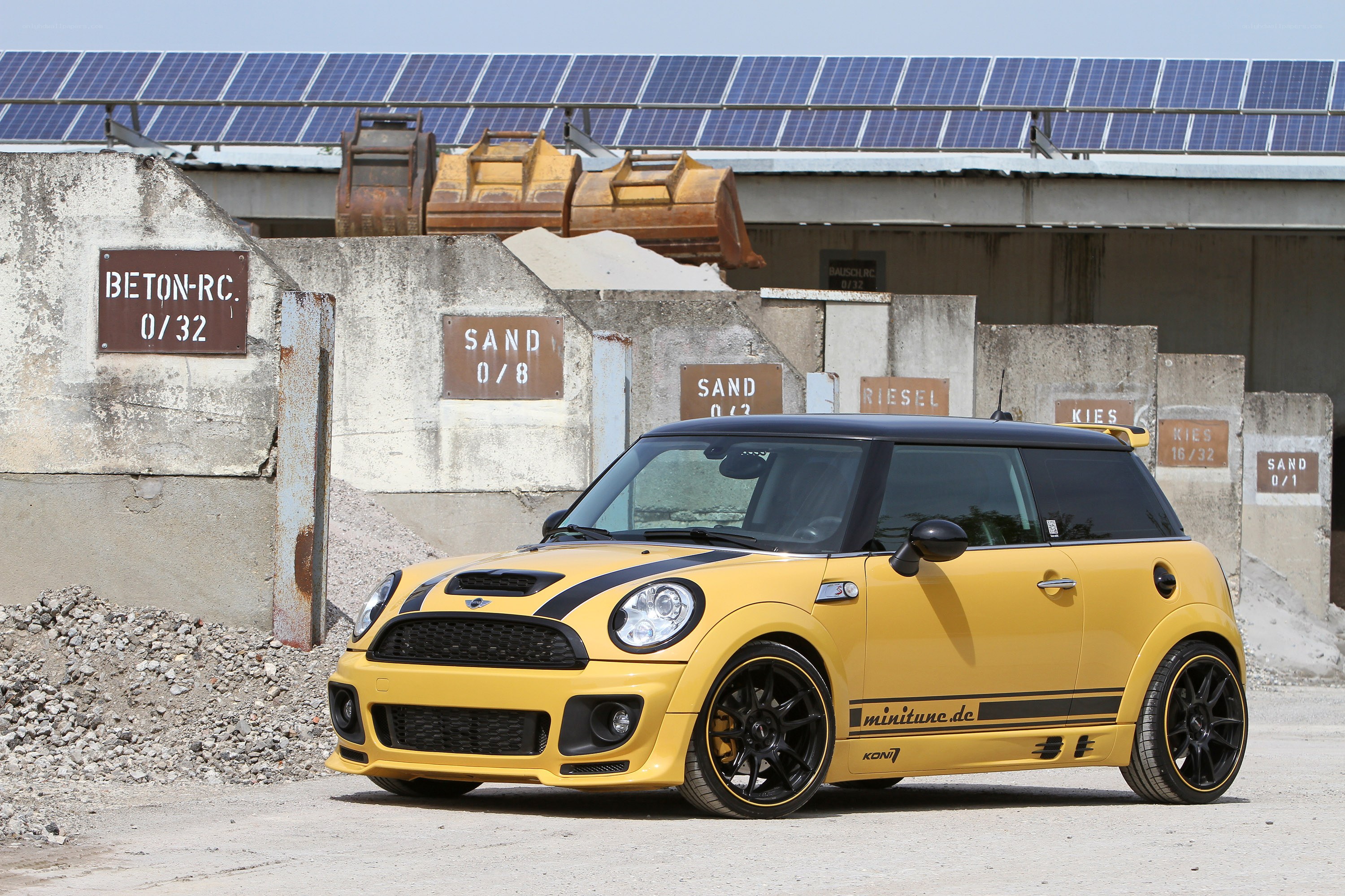 Yellow MINI Cooper in industrial setting