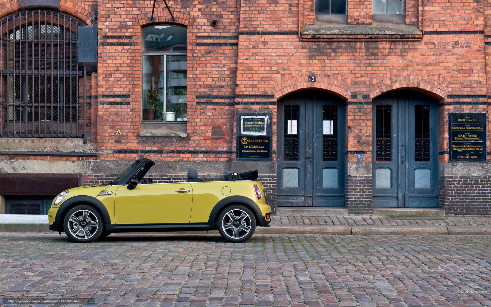 Yellow Mini Cooper on cobblestones