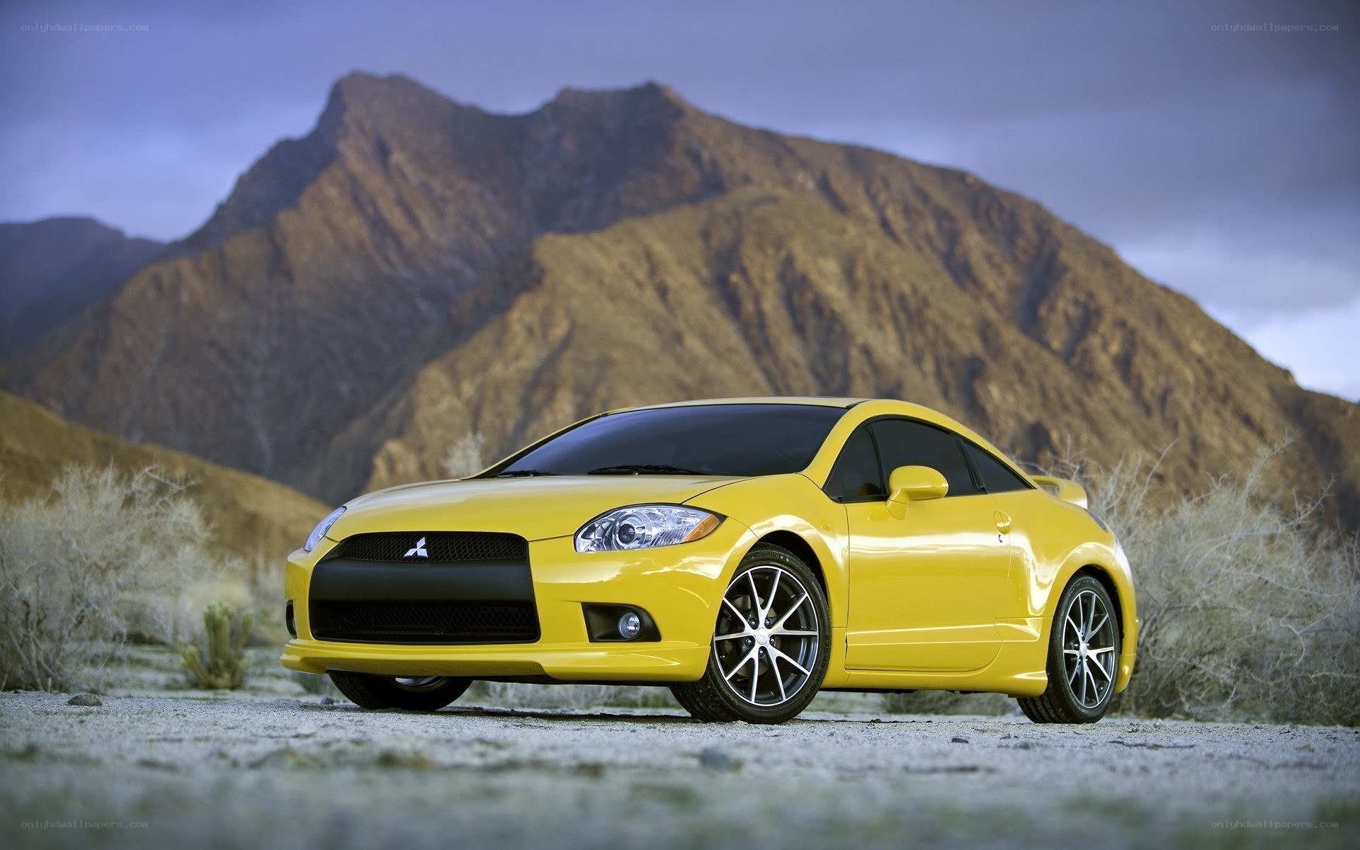 Yellow Mitsubishi Eclipse in desert