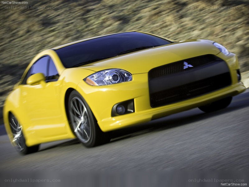 yellow mitsubishi eclipse in motion