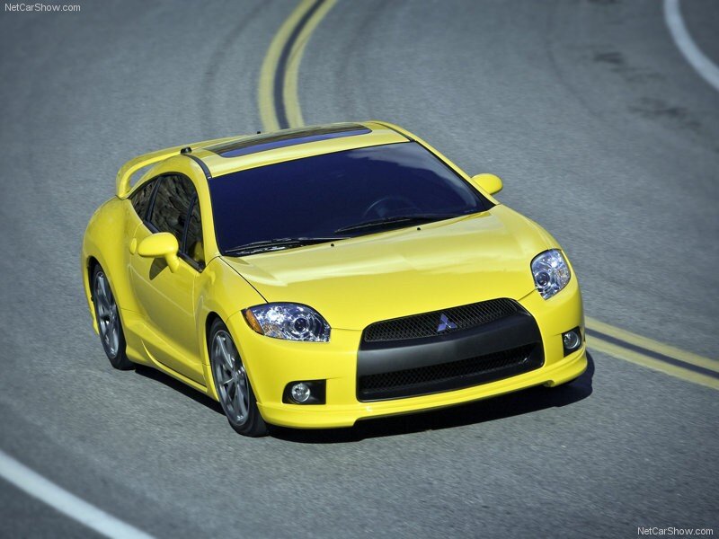 yellow mitsubishi eclipse on road