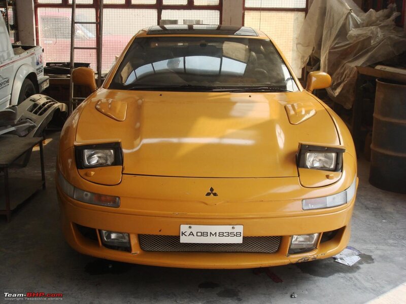 yellow mitsubishi sports car