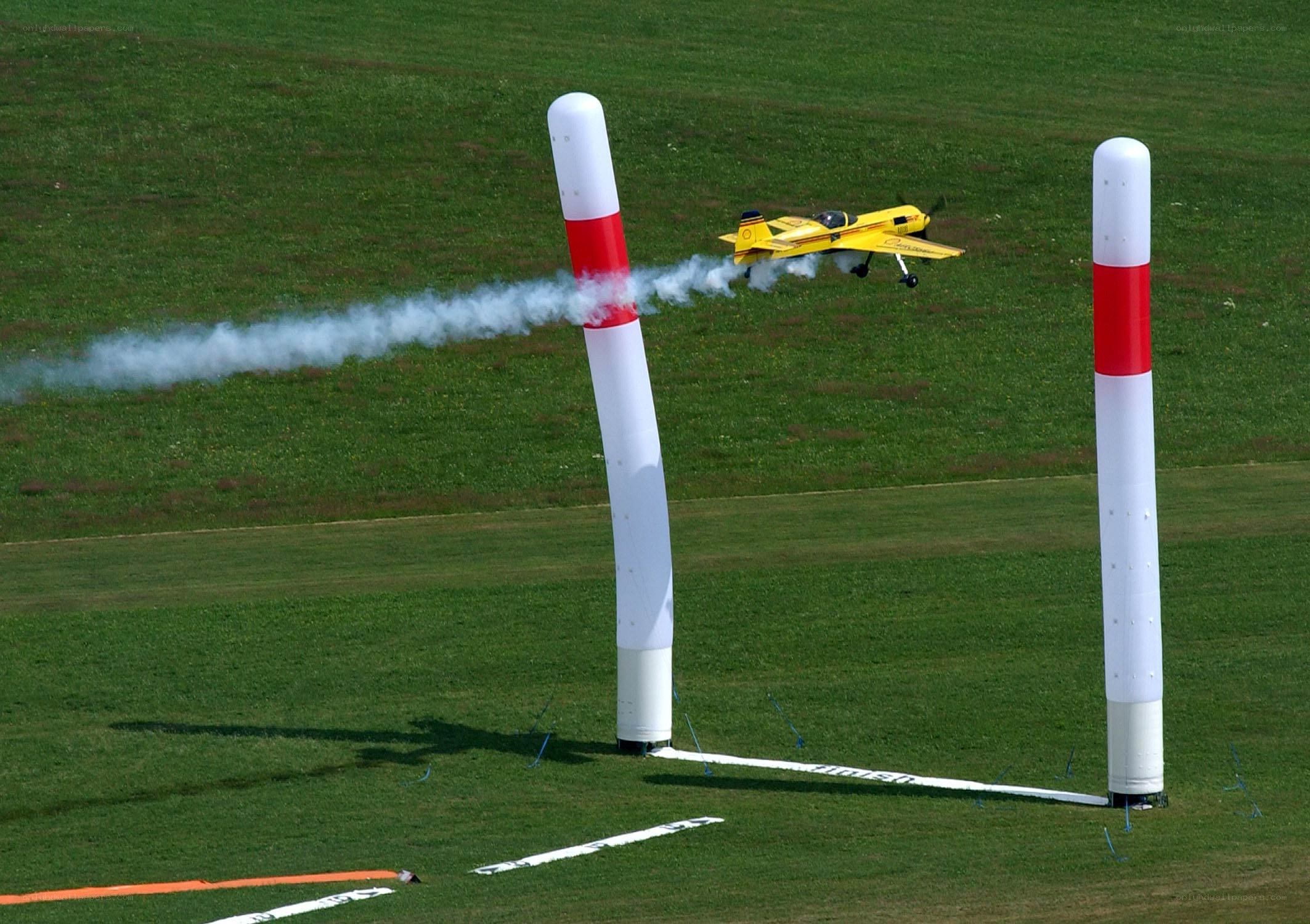Yellow model airplane flying through course