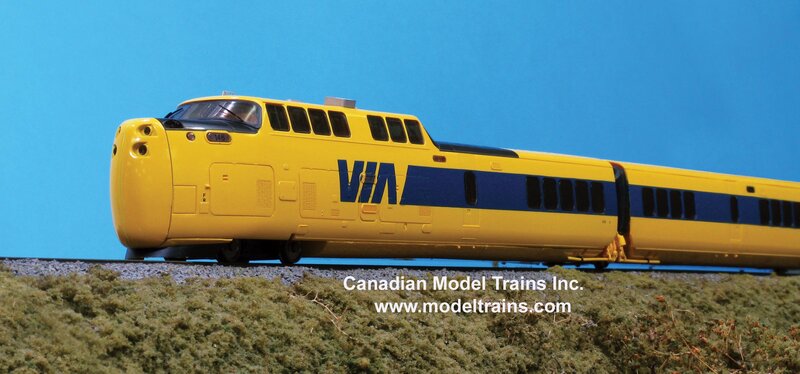 yellow model train on track