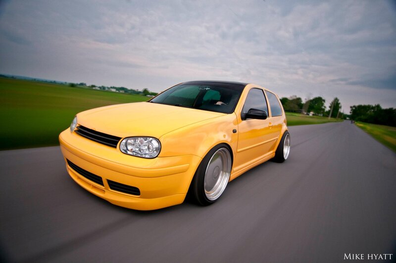 yellow modified car on road