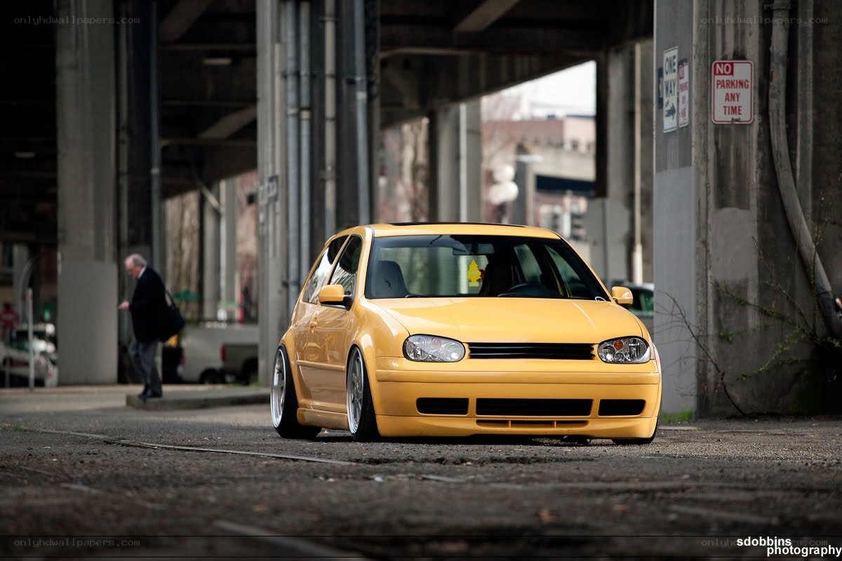 yellow modified car under overpass