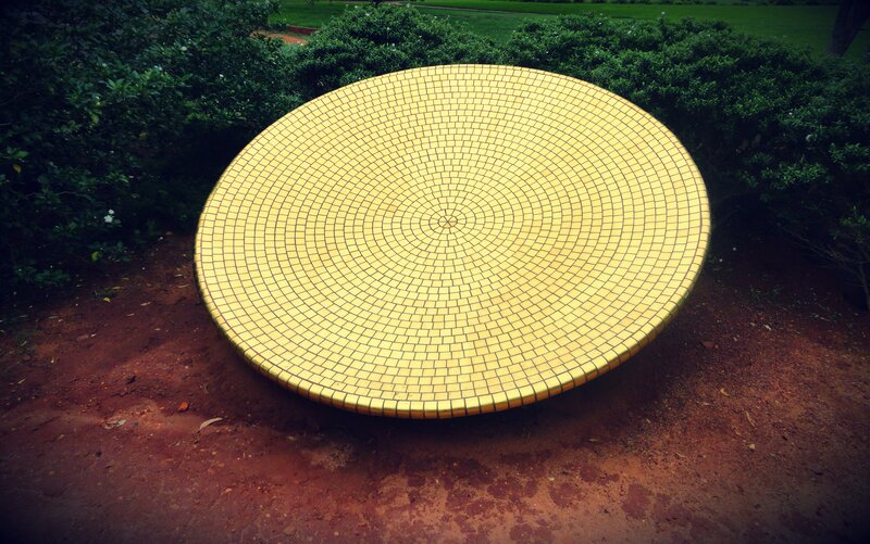 yellow mosaic sculpture in garden