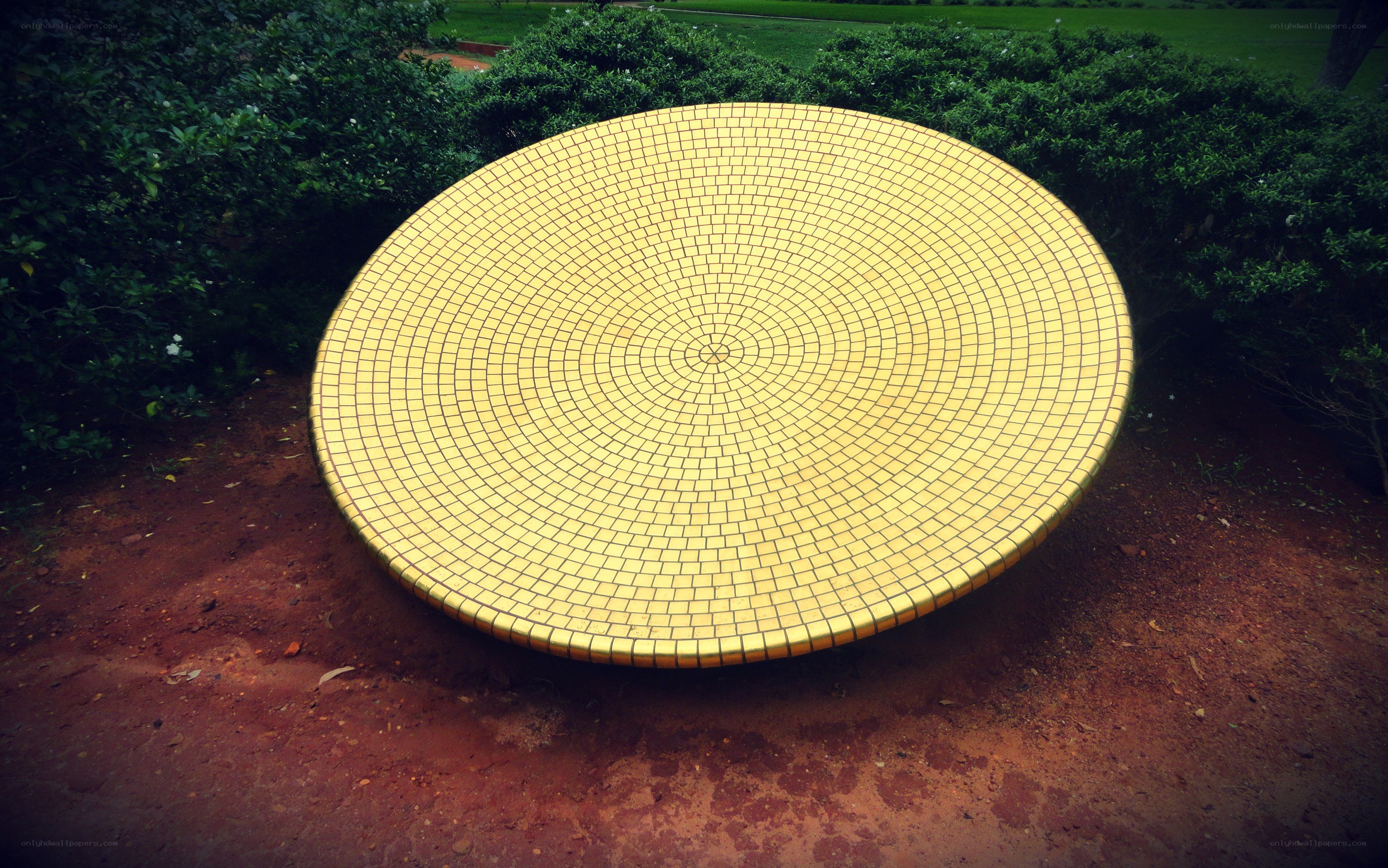 yellow mosaic sculpture in garden