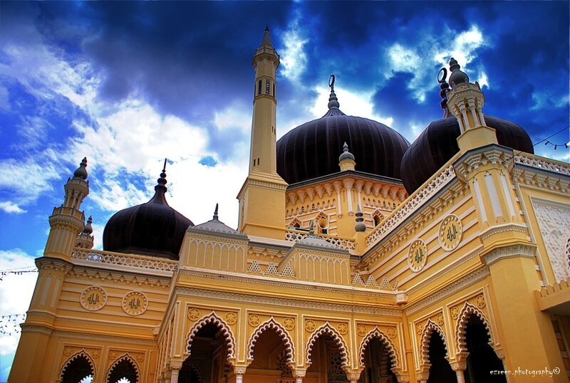Yellow mosque with black domes