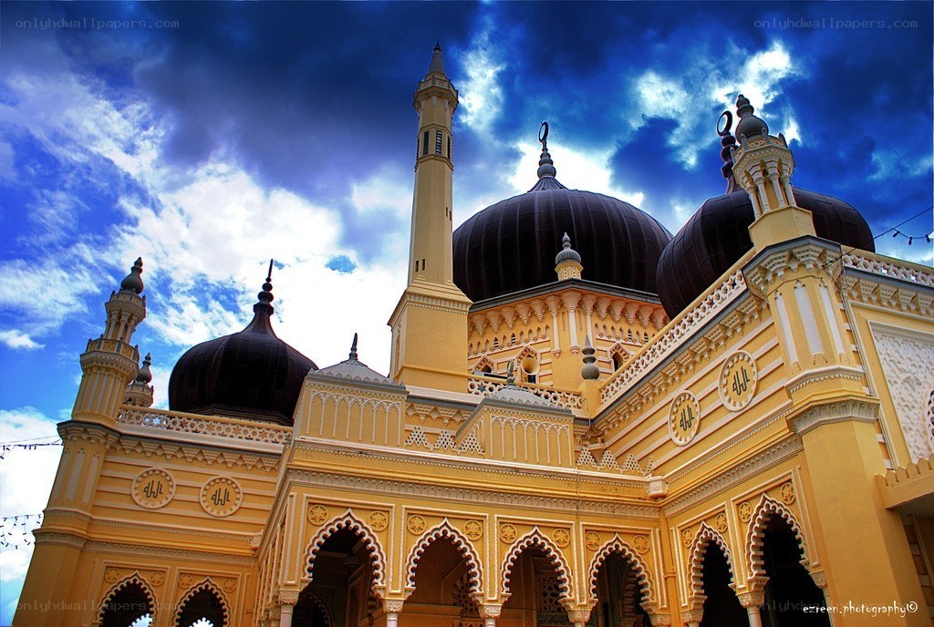 Yellow mosque with black domes