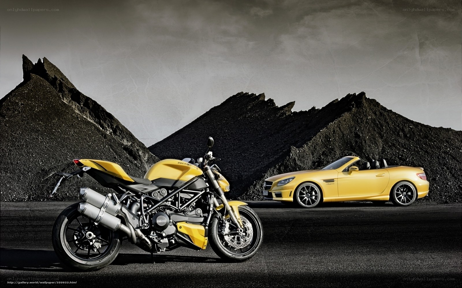 Yellow motorcycle and car in desert