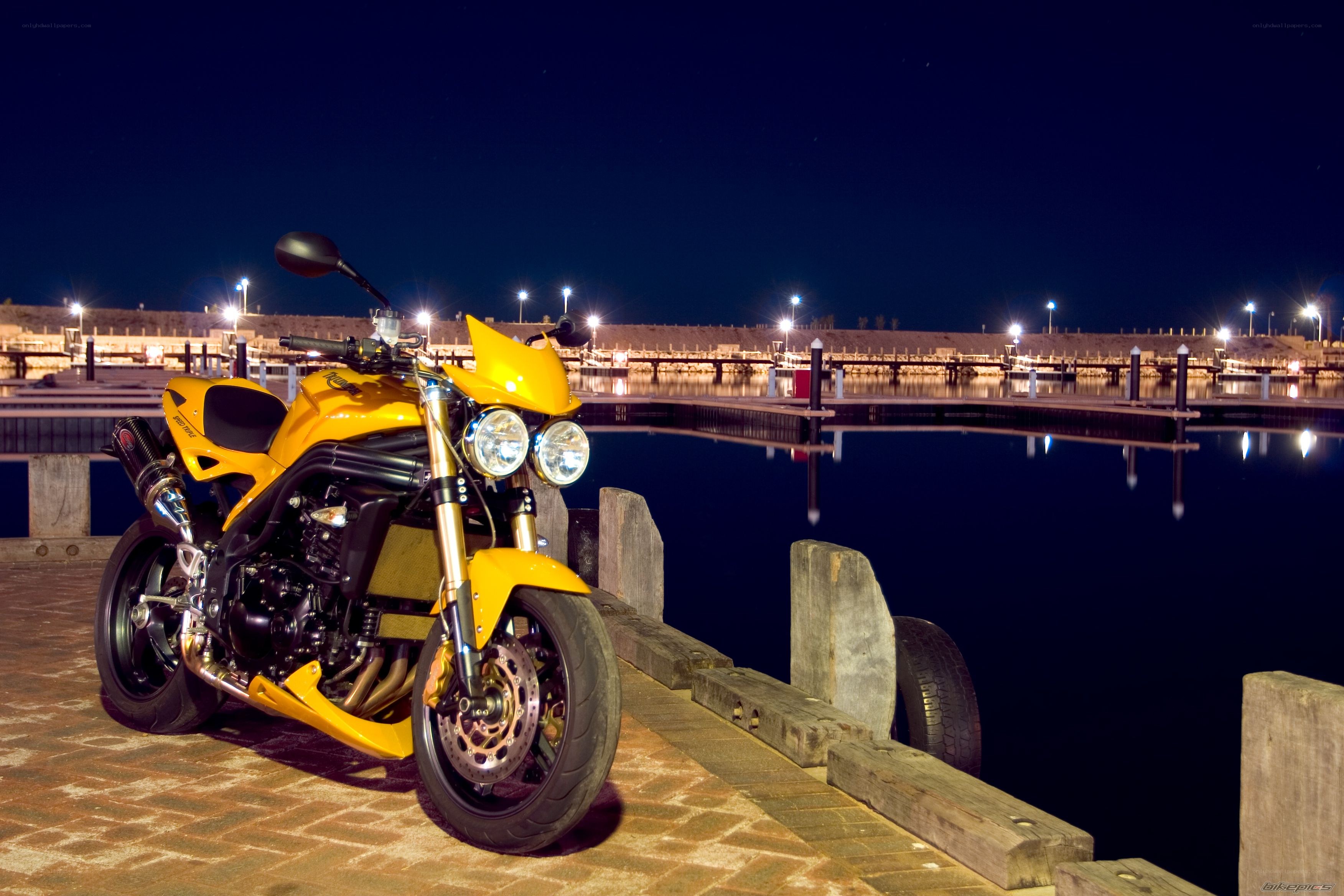 Yellow motorcycle at night dock