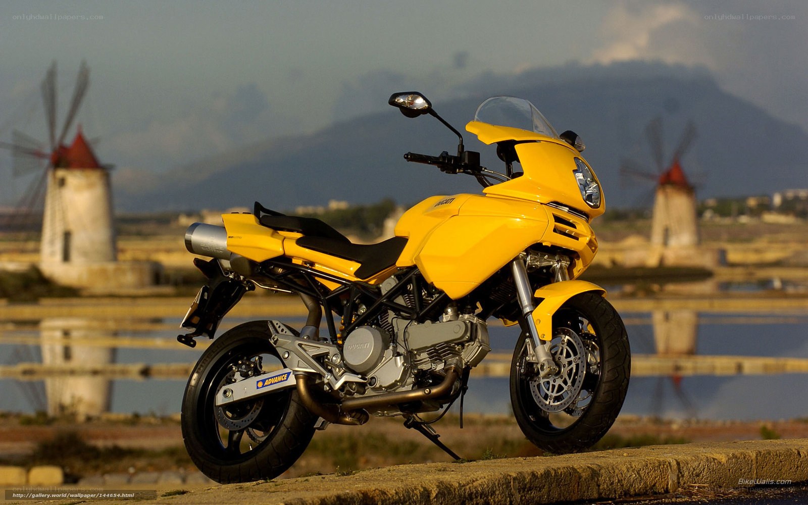 Yellow motorcycle by windmills
