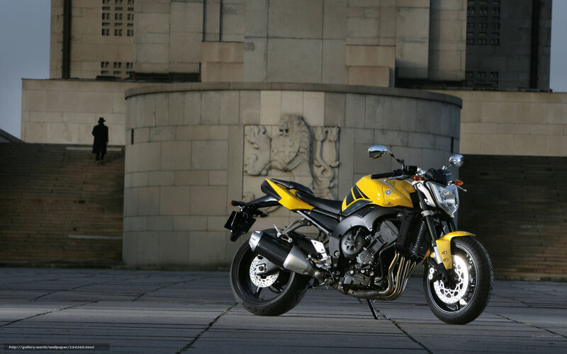 Yellow motorcycle in city square