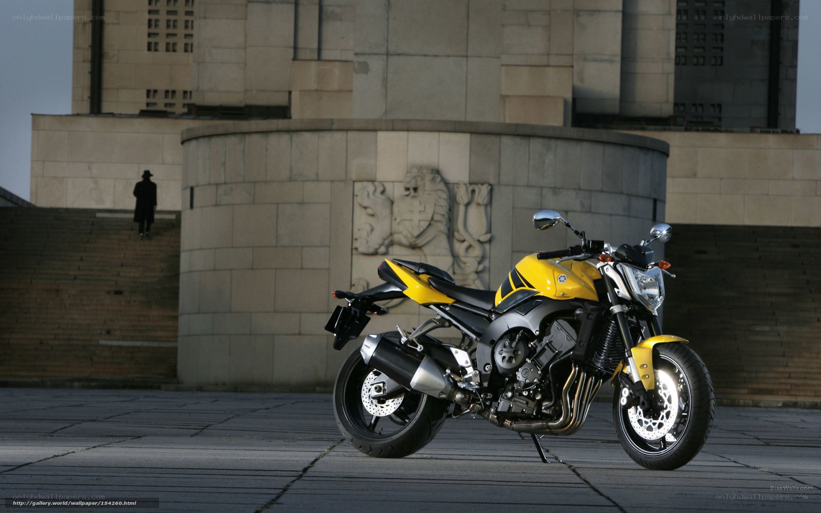 Yellow motorcycle in city square