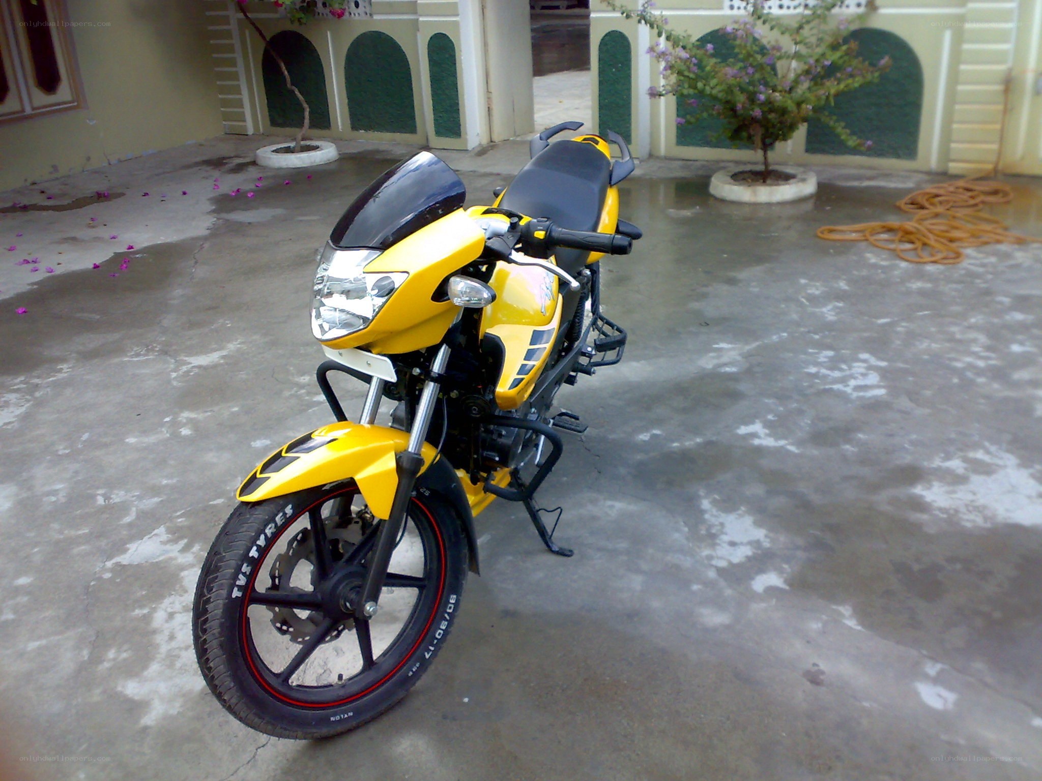 Yellow motorcycle in courtyard