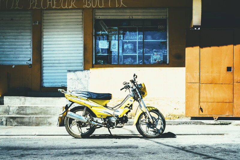 Yellow motorcycle parked on street