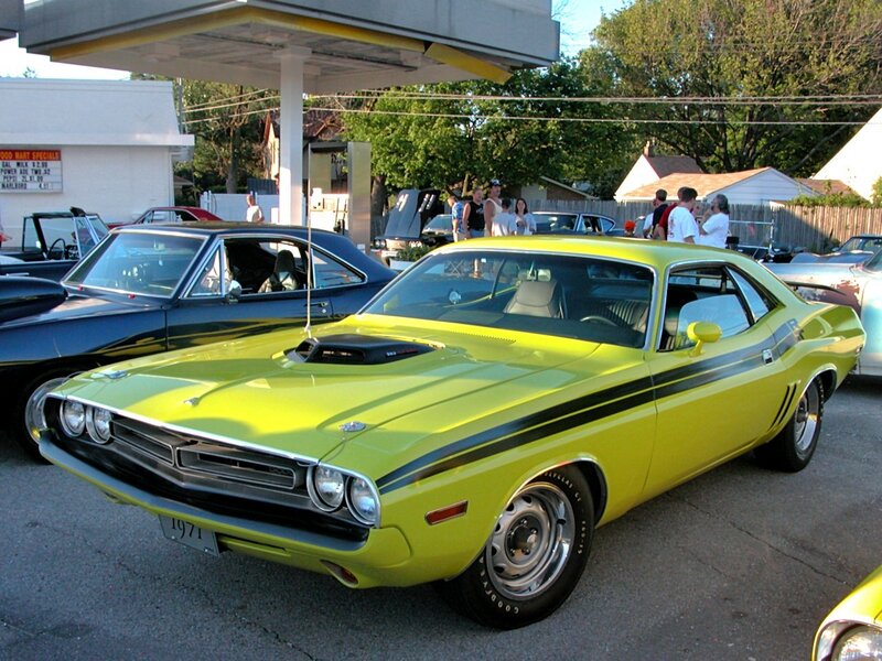 Yellow muscle car at a gas station