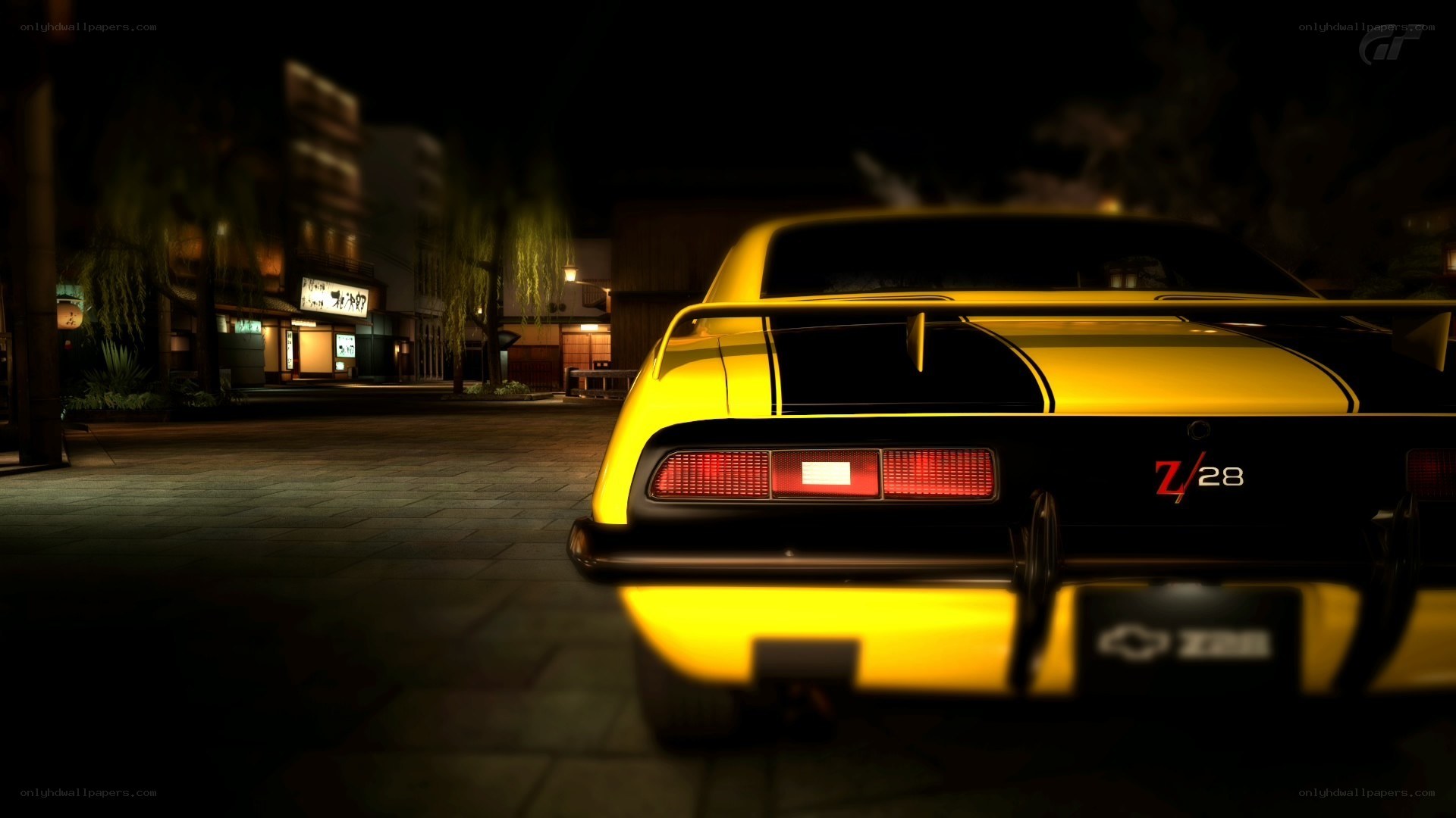 Yellow muscle car at night