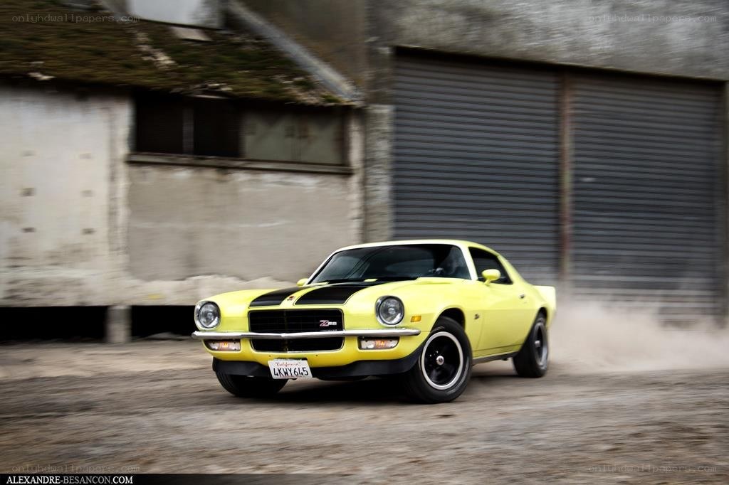 Yellow muscle car in motion