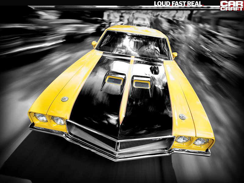 Yellow muscle car in motion