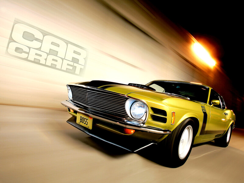 yellow muscle car in motion